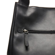 
Fioline Bolso de mano de cuero flor - Vista lateral mostrando el corte ergonómico de mangas